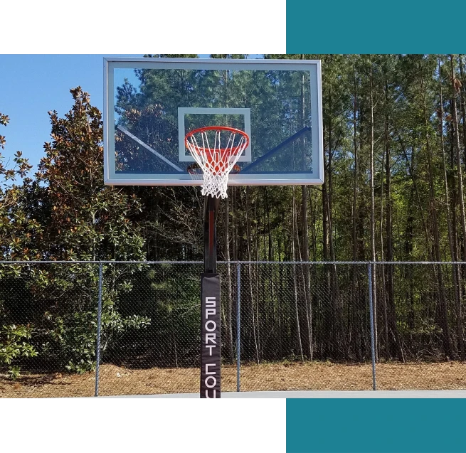 A basketball hoop in front of trees.