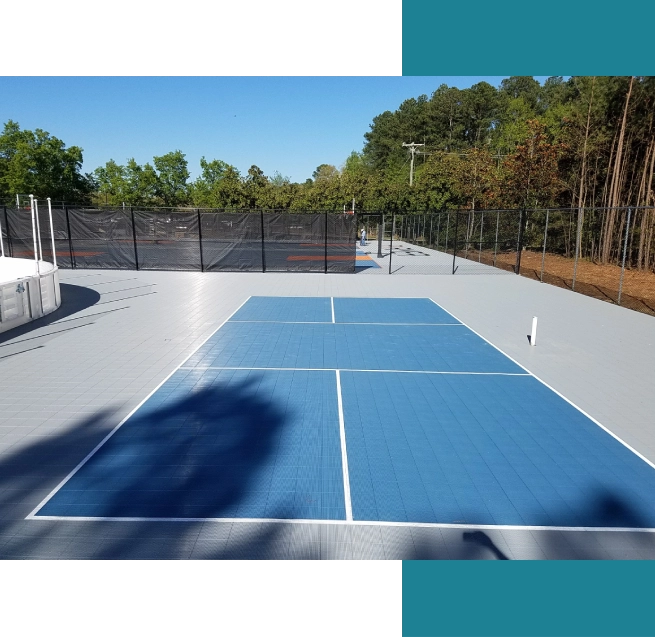 A tennis court with blue and white tiles